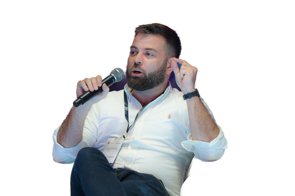 Kevin Chavanne speaking with a microphone during a startup ecosystem session.